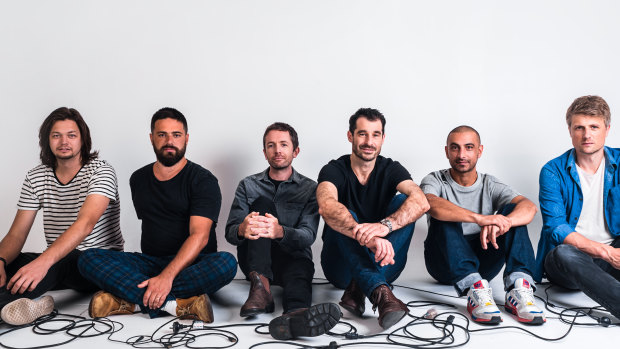 Felix Riebl (third from right) and his Cat Empire bandmates have weathered changing times and musical fashions.