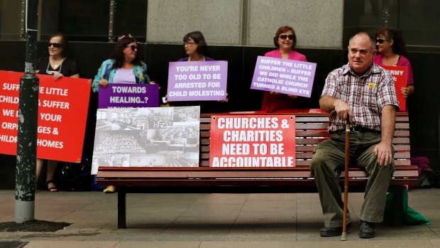 Les Johnson, who grew up in orphanages in the Newcastle and Gosford areas, sits outside the royal commission hearings in 2013. 