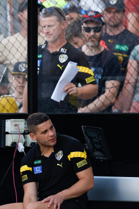 Dion Prestia of the Tigers looks on from the bench after leaving the field with a pectoral injury.
