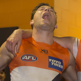 High note: Toby Greene belts out the club song.