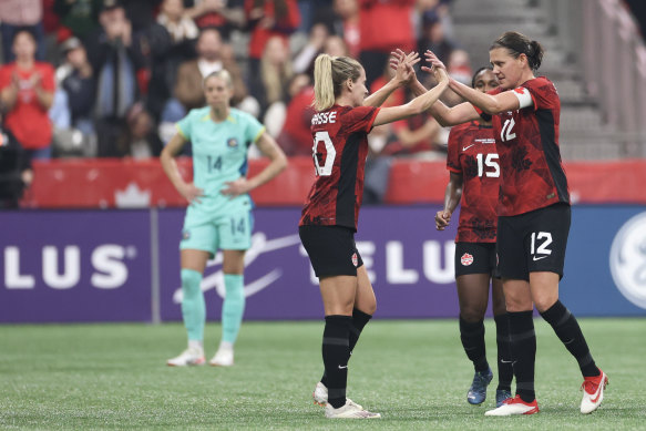 Christine Sinclair (No.12) and Cloe Lacasse celebrate Canada’s goal.