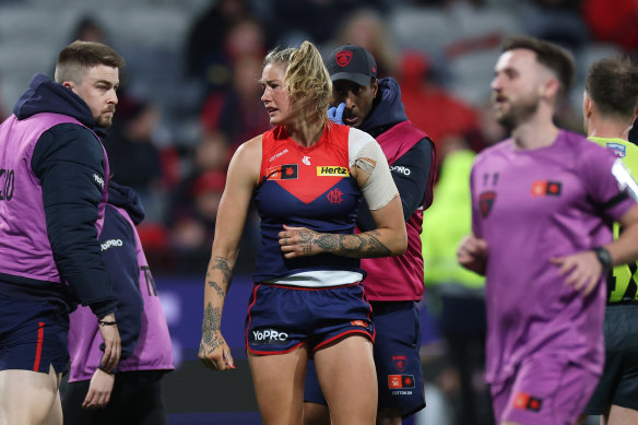 Melbourne’s Tayla Harris leaves the field after injuring her shoulder against Geelong in round one.