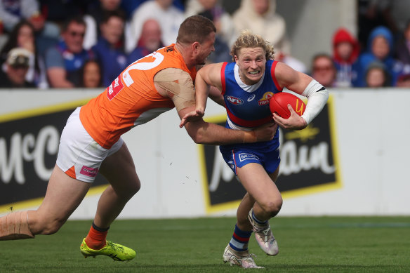 Cody Weightman breaks a tackle for the Bulldogs.