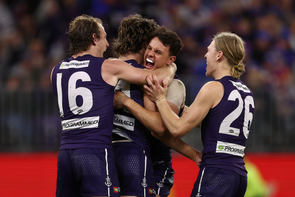 Jye Amiss celebrates a goal with David Mundy, Heath Chapman and Hayden Young.