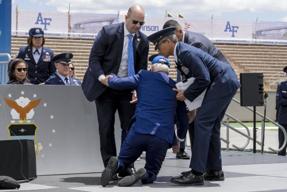 US President Joe Biden falls on stage during the 2023 United States Air Force Academy graduation ceremony in Colorado Springs.