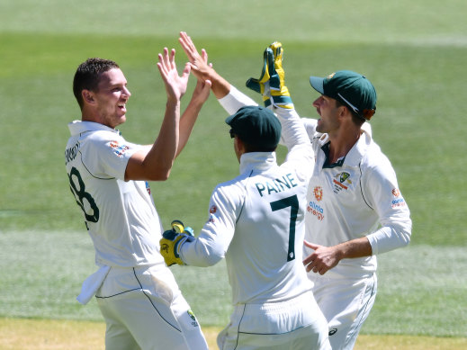 What a spell: Josh Hazlewood (left) celebrates the dismissal of Ravi Ashwin.