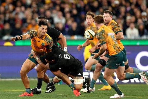 Jordan Petaia offloads for the Wallabies.