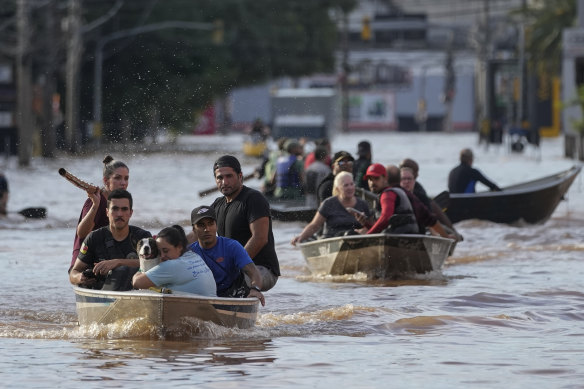 Volunteers help to evacuate residents from an area flooded by heavy rains, in Porto Alegre, Brazil, on Tuesday.