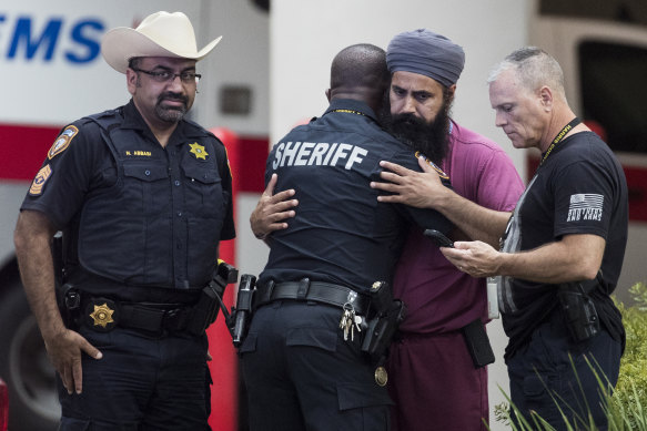 Colleagues and mourners outside Memorial Hermann Hospital in Houston where Sandeep Dhaliwal was taken after being shot.