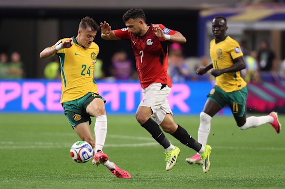 Paul Okon-Engstler (left) challenges Egypt’s Trezeguet for the ball.