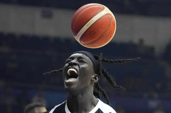 South Sudan centre Deng Acuoth scores against Angola at the FIBA World Cup and celebrates his country’s progression to the Olympics.