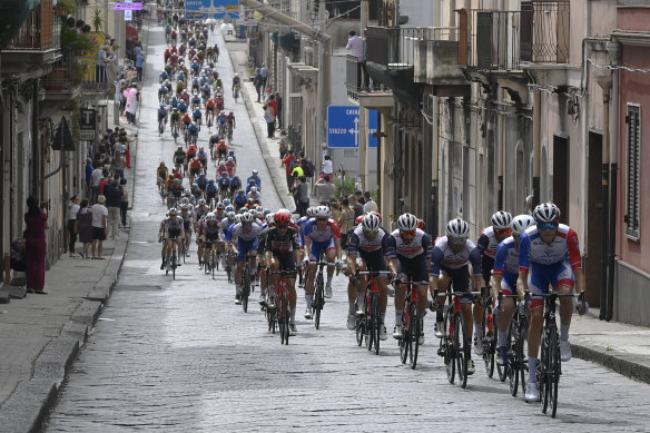 The peloton pedals through a village in the fourth stage from Catania to Villafranca Tirrena.
