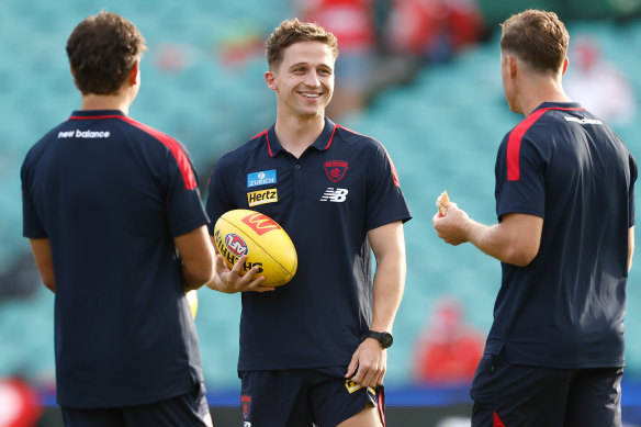Jack Billings of the Demons chats with teammates ahead of the game.