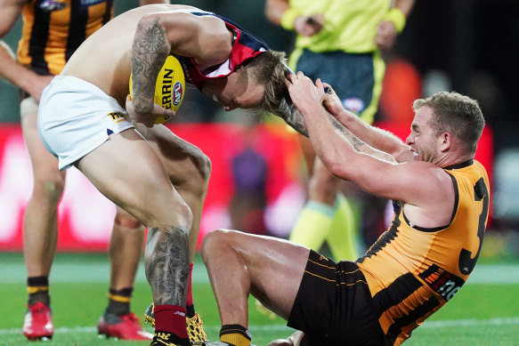 Tom Mitchell takes a firm grip on James Harmes’ jumper and refuses to let go.
