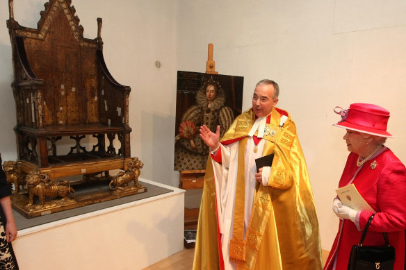 Dean of Westminster Dr John Hall shows Queen Elizabeth the Coronation Chair  in Westminster Abbey in 2010.