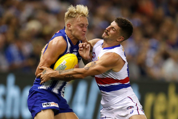 Jaiden Stephenson is tackled by Tom Liberatore.