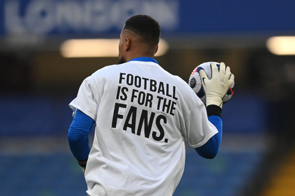 Robert Sanchez, of Brighton & Hove Albion, warms up wearing a T-shirt with a message before the team’s Premier League match against Chelsea on Tuesday.