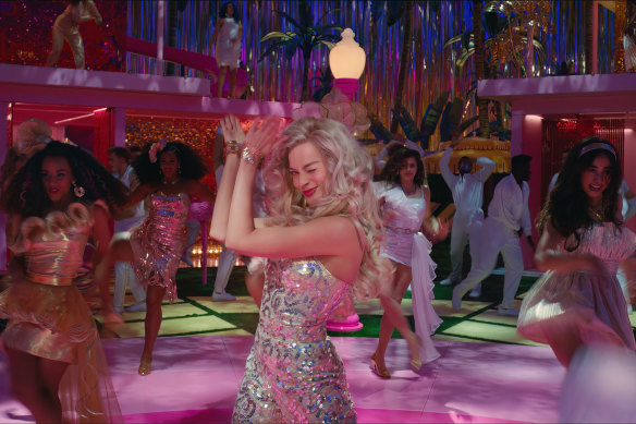 Margot Robbie as Barbie in her Dreamhouse where “every night is girls’ night!”