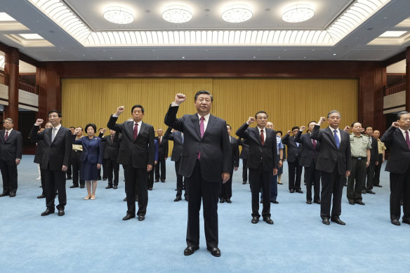 President Xi Jinping, centre, reviews with Communist Party admission oath on a visit to the Museum of the Communist Party of China. 