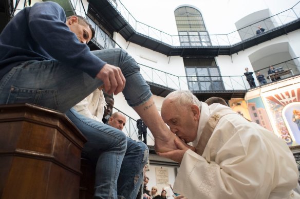 Pope Francis washes the feet of an inmate at the Regina Coeli prison in 2018.