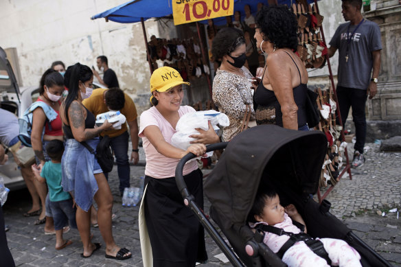 People collect food donated by aid groups in Rio de Janeiro, Brazil, on Wednesday. 