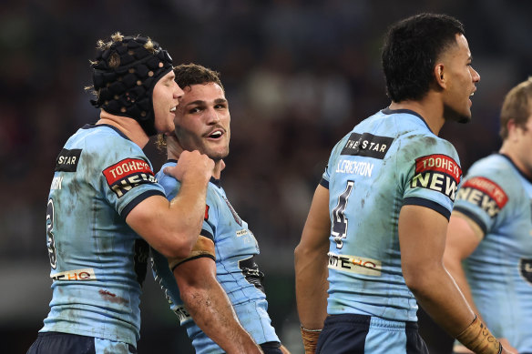 Matt Burton and Nathan Cleary celebrate a NSW try with Stephen Cricthon (right) in Origin II.