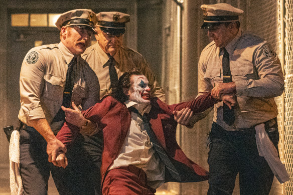 Brendan Gleeson (left) as Jackie Sullivan and Joaquin Phoenix as Arthur Fleck in <i>Joker: Folie a Deux</i>.