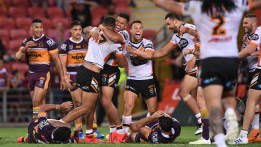 Game over: The Tigers celebrate while the Broncos wonder what just happened.