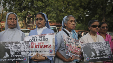 Catholic nuns and others participate in a vigil outside Sacred Heart Cathedral in remembrance of victims.