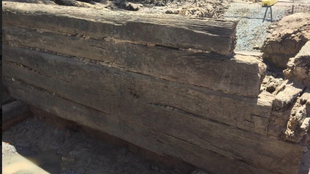 Old hand-hewn timber logs which are part of a pre-1860's bridge discovered under Kingsford Smith Drive.