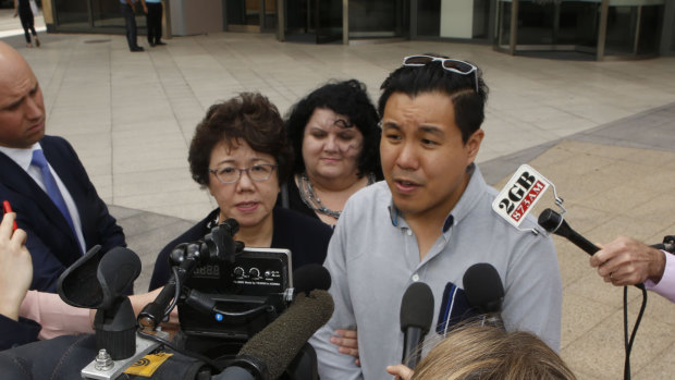 Curtis Cheng's son Alpha Cheng and widow Selina Cheng speak outside the court