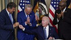 President Joe Biden hands the pen he used to sign the Democrats’ landmark climate change and health care bill to Senator Joe Manchin. Also pictured is Senate Majority Leader Chuck Schumer and Majority Whip James Clyburn. 