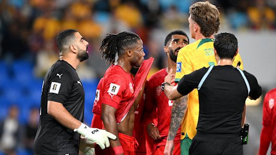 Harry Souttar exchanges words with Bahrain players last September.