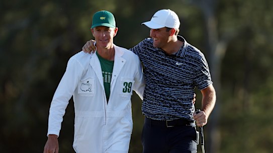 Scottie Scheffler celebrates with caddie Ted Scott on the 18th green at Augusta.