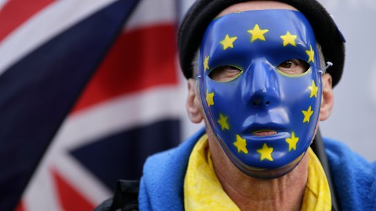 An anti-Brexit demonstrator wears a mask bearing stars of the European flag, during a protest outside the houses of Parliament in London last month.