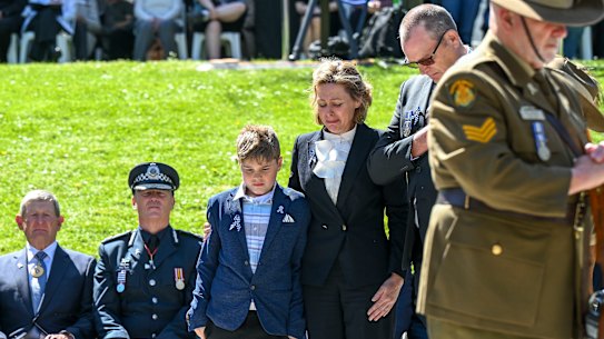 Sergeant Lisa Thompson and her son at the National Police Remembrance Day service at the Kings Domain. 