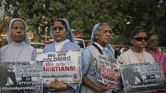 Catholic nuns and others participate during a vigil outside Sacred Heart Cathedral  in remembrance of victims.