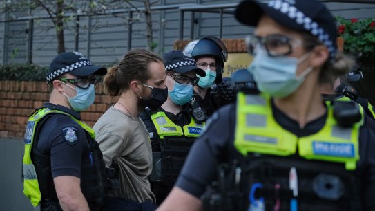 A man is arrested while protesting on Saturday.