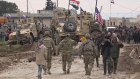 Russian, Syrian and others gather next to an American military convoy stuck in the village of Khirbet Ammu, Syria. In a world gripped by a pandemic, global unrest and a fast-moving news cycle, it can be difficult to remember that the war in Syria is still happening. 