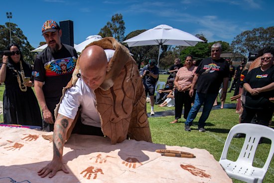 Mutti Mutti and Wamba Wamba man Jason Kelly puts his hand print on the kangaroo-skin treaty document.