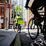 Cyclists at the corner of King and Clarence St in the CBD, where the King St cycleway disappears as you head east.