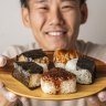 A plate of onigiri held by Comeco Foods co-owner Masa Haga.