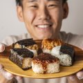 A plate of onigiri held by Comeco Foods co-owner Masa Haga.