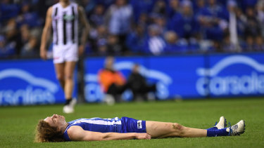 Down for the count: North Melbourne footballer Ben Brown.