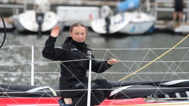 Greta Thunberg waves to her supporters on her arrival in New York aboard the zero-emissions yacht Malizia II.
