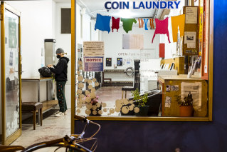 A Melbourne resident takes advantage of the curfew lifting to do some late-night laundry.