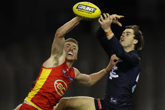 Gold Coast’s Jacob Townsend and Lachie Plowman of the Blues fly for the ball.