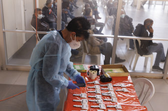A medical worker waits for Covid-19 antigen tests results at the Erez Crossing on the Israel-Gaza border, in Erez, Israel. 