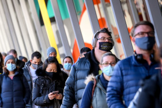People queue up for COVID-19 vaccinations at the Melbourne Convention and Exhibition Centre. 