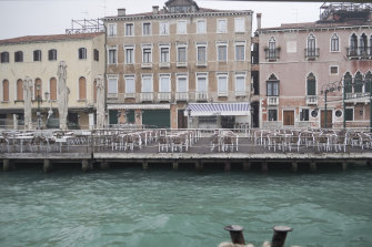 Chairs left empty at cafes in Venice this week as travellers stayed away. 